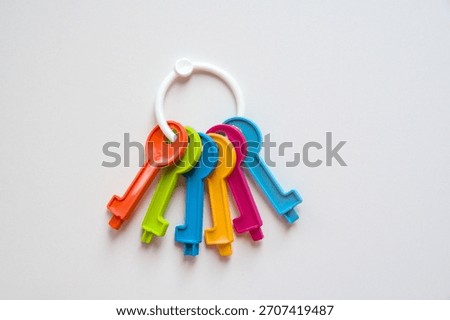 bunch of multi-colored plastic keys on a white background. Children's toy. High quality photo