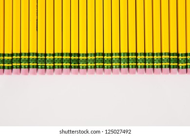 A Bunch Of Number 2 Pencil Erasers, Laid Out In A Row, On A White Background.