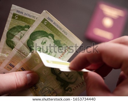 Bunch of old Deutsche Mark in the male hand background