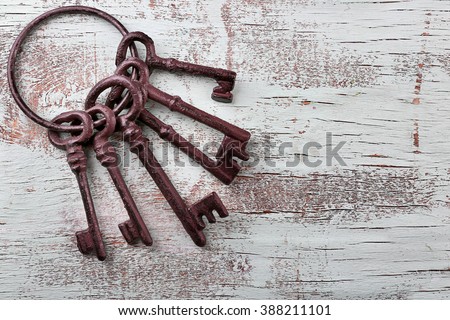 Bunch of old keys on blue wooden background, close up