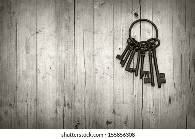 bunch of old keys on wooden background black and white