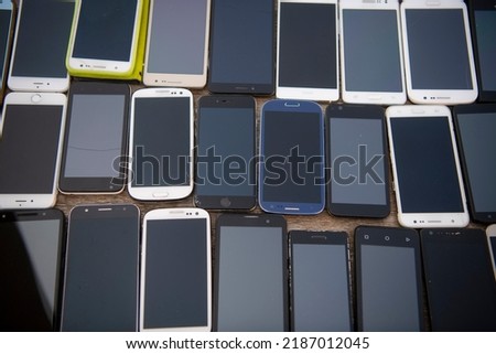 Bunch of old used mobile phones on street market. Equipment repair and maintenance services. Parts for assembly.