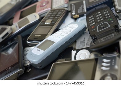 Bunch of old used outdated mobile phones and batteries. Recycling electronics