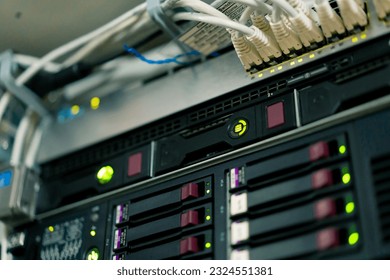 a bunch of patch network cables sorted in a rack cabinet leading from a patch panel in a server rack in data center room internet cloud storage