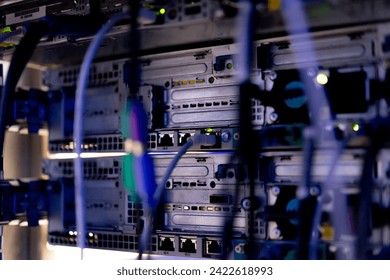 a bunch of patch network cables sorted in a rack cabinet leading from a patch panel in a server rack in data center room internet cloud storage