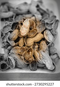 A bunch of peanut shells isolated on white Styrofoam. Image of a peanut shell with a circle of light in the center, and  a black and white background