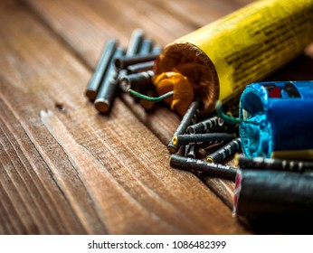 bunch of petards and firecrackers on a wooden surface close up