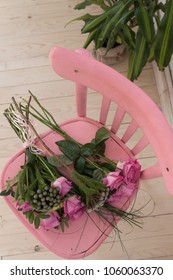 Bunch Of Pink Roses Lying On Pink Shabby Chic Style Wooden Chair Decorated With Decoupage Technique. Beautiful Flowers For A Romantic Evening, Close Up