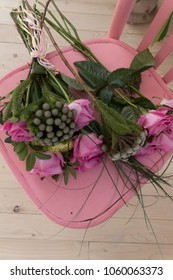 Bunch Of Pink Roses Lying On Pink Shabby Chic Style Wooden Chair Decorated With Decoupage Technique. Beautiful Flowers For A Romantic Evening, Close Up