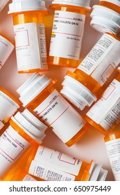 A Bunch Of Prescription Pill Bottles Grouped On A Table With White Background