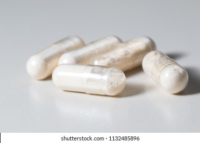 Bunch of  probiotics capsules on white background