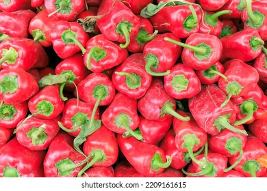 Bunch Of Red Fresh Organic Peppers, Paprika At The Village Market Counter, Juicy All Natural Sweet Red Capia Peppers Stack At Farmers Market, Top View. 