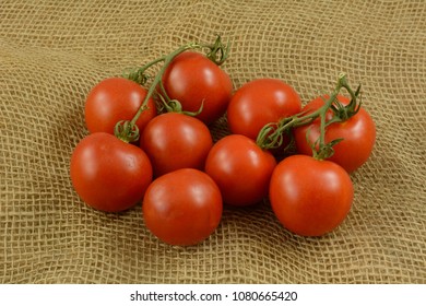 Bunch Of Red Ripe Campari On Vine Tomatoes On Burlap