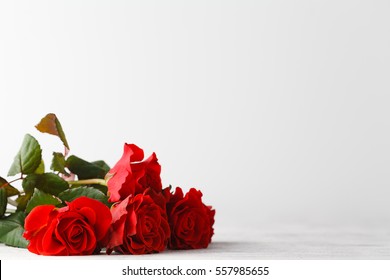 Bunch of red roses on table - Powered by Shutterstock