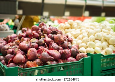 Bunch Of Red And Silver Onions On Boxes In Supermarket