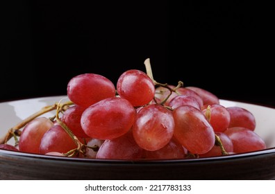 Bunch Of Ripe Red Grapes In A Plate Side View. Red Grape Taifi