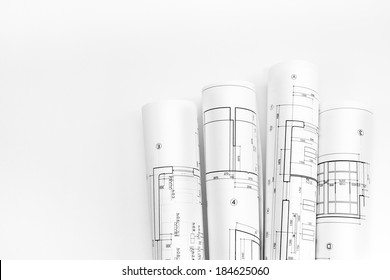 Bunch Of Rolled Up Building Plans And Technical Drawings