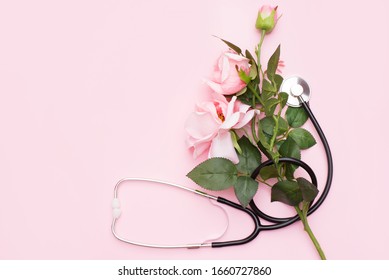 Bunch Of Rose Flowers And Stethoscope On Pink Background. National Doctor's Day. Happy Nurse Day. Top View With Copy Space