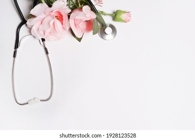 Bunch Of Rose Flowers And Stethoscope On White Background. National Doctor's Day. Happy Nurse Day. Top View With Copy Space