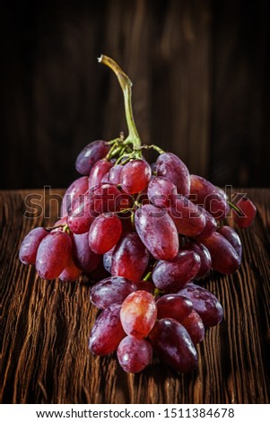 bunch of rose grape on vintage wooden board