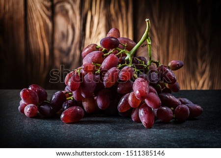 bunch of rose grape on vintage wooden background