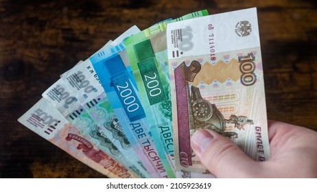 Bunch of Russian rubles are counted in the male hand - Shutterstock ID 2105923619