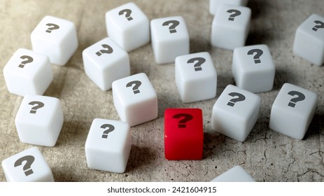 A bunch of small cubes with question mark symbols on the table. Curiosity concept