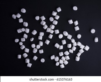A bunch of small marshmallows isolated on black background