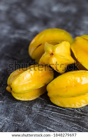 a bunch lot of star fruit close up dark table