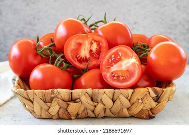 Bunch tomatoes. Fresh tomatoes in basket on stone floor. Organic food. close up