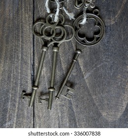 bunch of vintage keys on old wooden plank, from above