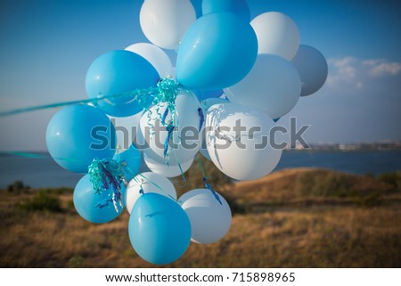 A bunch of white and blue balls against the background of the river