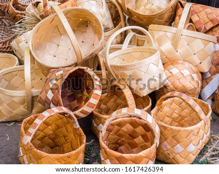 A bunch of wicker baskets in retro style. Heap of birch baskets. Pile of birch bark bast baskets.