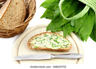 Bunch Of Wild Garlic (ramson) And Bread Slice With Ramson Butter And Antique Silverware On Isolated White Background