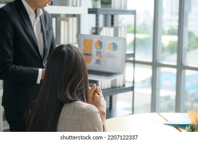 A Bunch Of Young Asian Businesspeople. Meeting In A Room With Windows For Natural Light To Discuss Stock Investing Data.