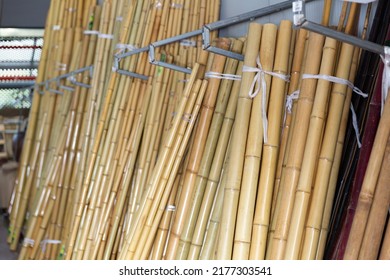 Bunches of bamboo poles in gardening shop or storage house.