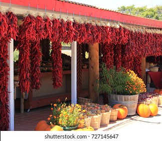 Bunches of dried red chilies strung in front of a store in Taos, New Mexico