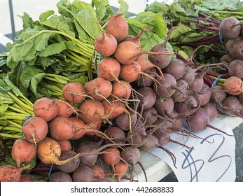 Bunches Of Gold And Red Beets For Sale At An Outdoor Farmers Market