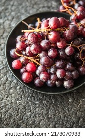 Bunches Of Red Grapes On Old Black  Wooden Table . Symbol Of Autumn Cornucopia, Top View