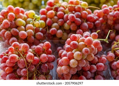 Bunches Of Red Ripe Juicy Grapes In A Tray On The Counter. The Concept Of Fortification.