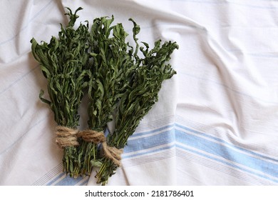 Bunches Of Wilted Mint On White Towel, Flat Lay. Space For Text