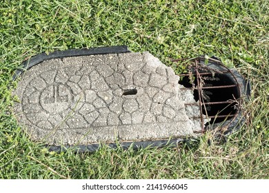 Bundaberg, queensland, Australia, May 30 2021. Broken concrete lid on a small manhole used for telecomunication.