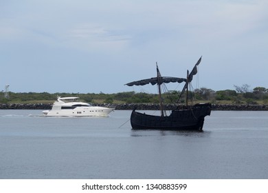 Bundaberg, Queensland/Australia- December 9 2017: A Gaff Rigged Schooner At Anchor In Passed By A Modern Luxury Motor Boat In The Burnett River In Bundaberg, Australia.