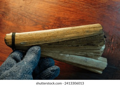 Bundle of ancient palm leaves dried palm leaf for manuscripts in wooden background, its used as writing material in ancient times, blank dried palm leaf with text space. top view,side view