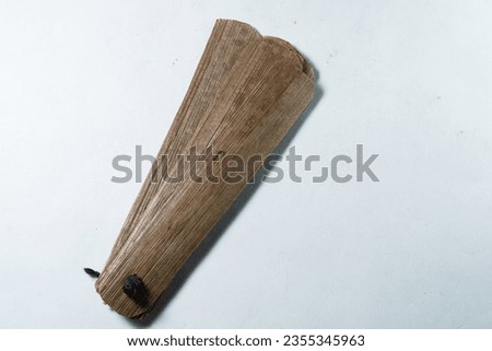 Bundle of ancient palm leaves dried palm leaf for manuscripts in white background, its used as writing material in ancient times, blank dried palm leaf with text space. top view,side view.