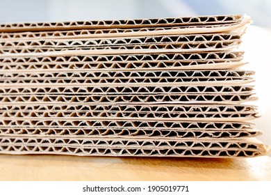 Bundle Of Brown Paperboard Packaging Stack, Ready For Shipping. Abstract Rough Detail Pattern And Wavy Horizontal Lines At A Side View Of The Container Box Texture. Recycle Paper Package.