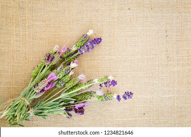 Bundle Of Fresh Purple Lavender Tied With Jute String On Burlap Background