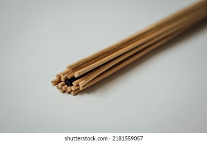 Bundle Of Light Brown Diffuser Reeds With One Black Reed Hidden Within