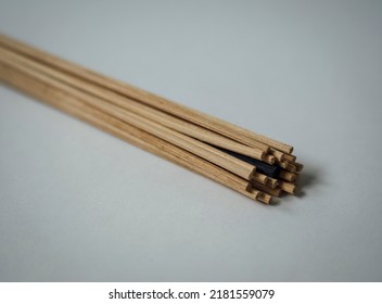 Bundle Of Light Brown Diffuser Reeds With One Black Reed Hidden Within