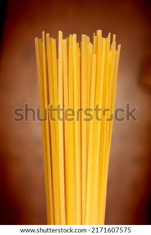 A bundle of linguine on a  brown background